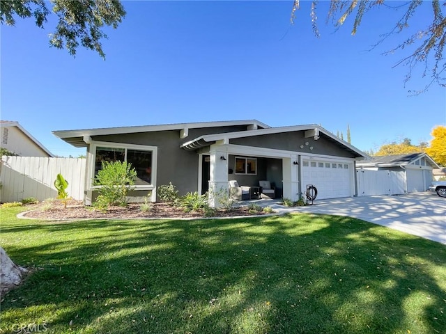 view of front of house with a garage and a front lawn