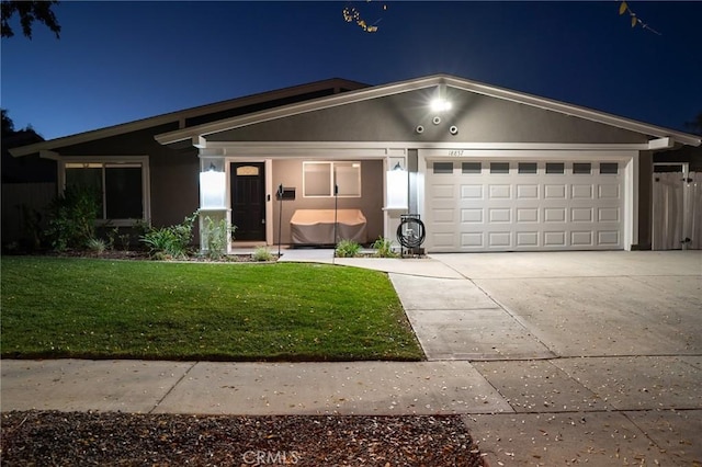 view of front facade with a yard and a garage