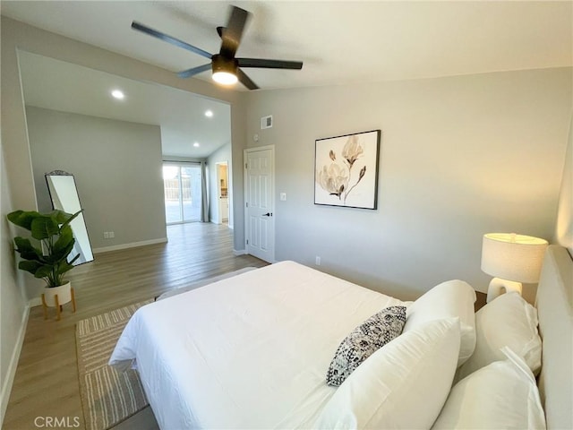 bedroom featuring wood-type flooring, ceiling fan, and lofted ceiling