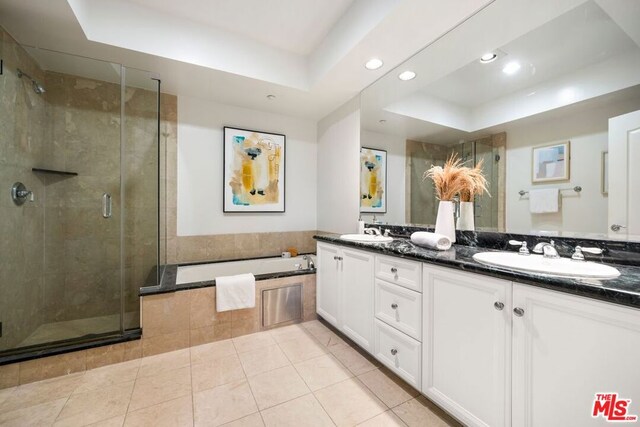 bathroom featuring vanity, a raised ceiling, separate shower and tub, and tile patterned flooring