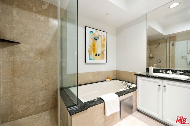 bathroom featuring tile patterned flooring, shower with separate bathtub, and vanity