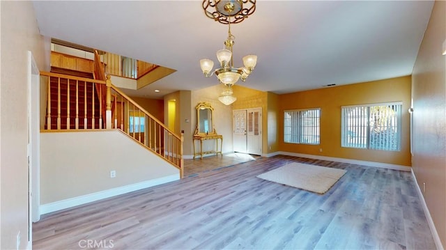 foyer entrance with an inviting chandelier and light hardwood / wood-style flooring