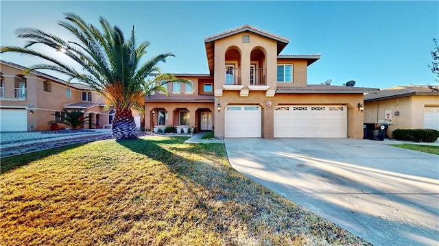 mediterranean / spanish home with a garage, a balcony, and a front yard