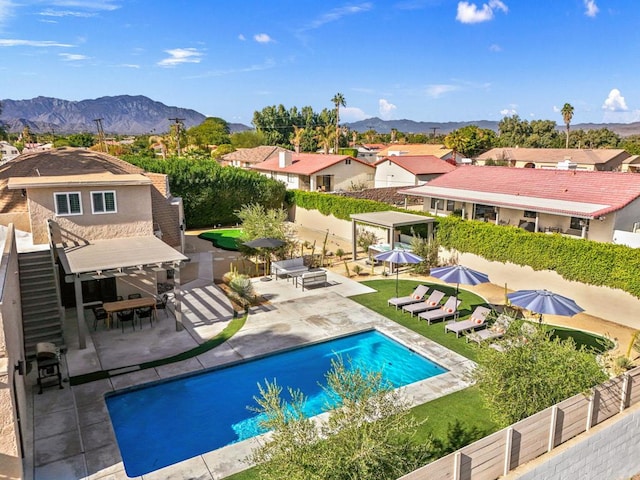 view of pool featuring a patio area and a mountain view