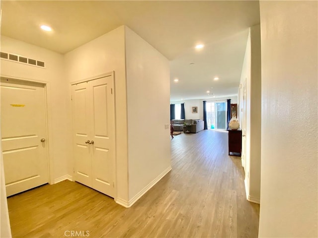 hall with light hardwood / wood-style flooring