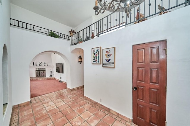 carpeted foyer entrance with a high ceiling