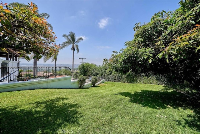 view of property's community featuring a lawn and a water view