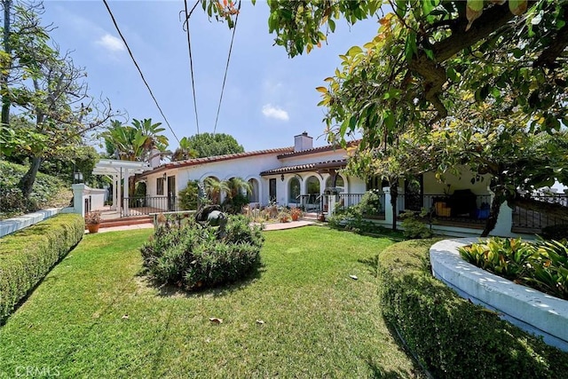 rear view of house featuring a lawn