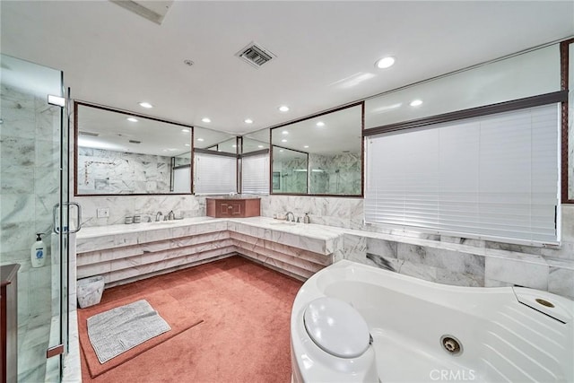 bathroom with vanity and separate shower and tub