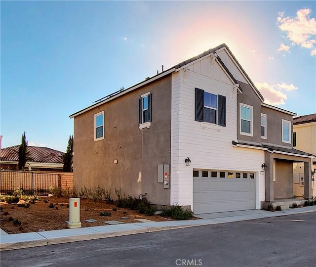 property exterior at dusk with a garage