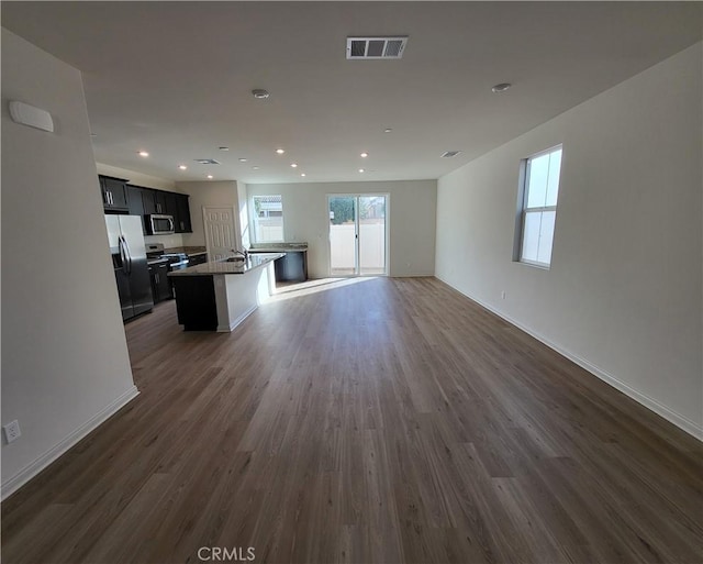 unfurnished living room featuring dark hardwood / wood-style floors