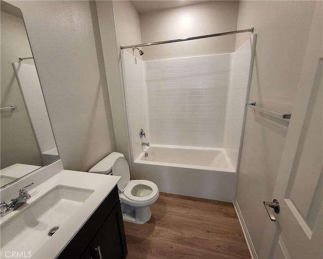 full bathroom with hardwood / wood-style flooring, vanity, toilet, and shower / tub combination