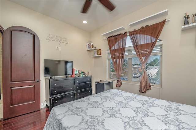 bedroom with ceiling fan and dark hardwood / wood-style floors