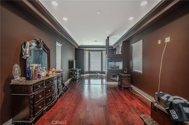 hallway with dark hardwood / wood-style floors and ornamental molding