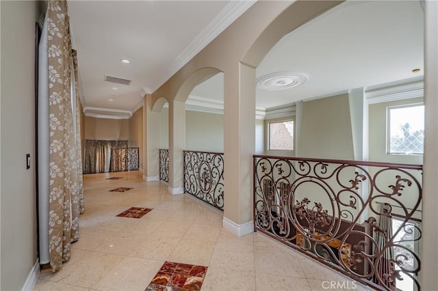 hallway featuring crown molding and light tile patterned flooring