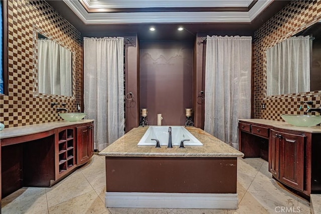 bathroom featuring a raised ceiling, vanity, and ornamental molding