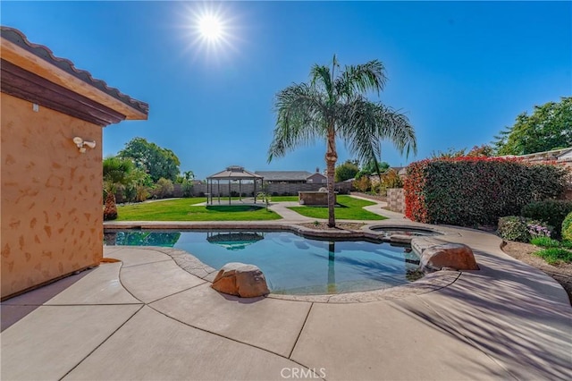 view of swimming pool featuring a gazebo, an in ground hot tub, and a yard