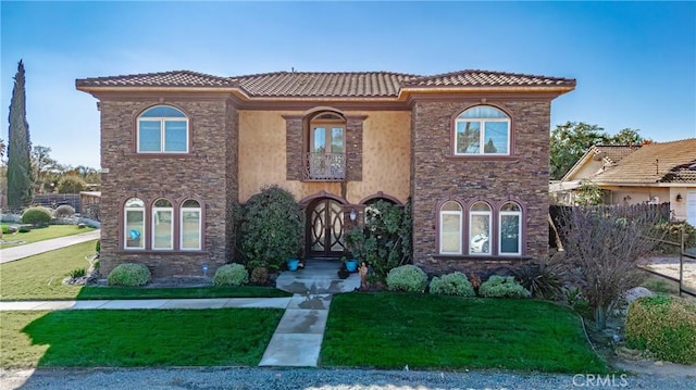 mediterranean / spanish-style house with a front yard