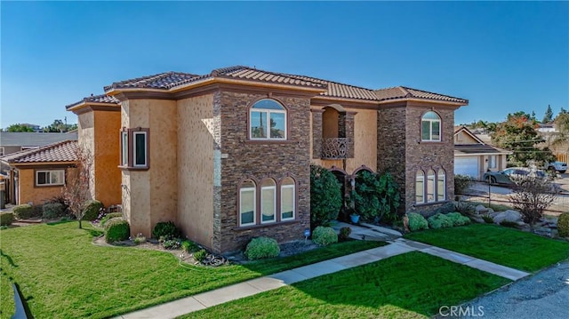 mediterranean / spanish-style house featuring a front lawn