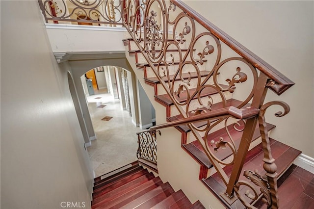 staircase with hardwood / wood-style flooring