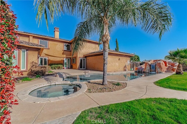 view of pool featuring an in ground hot tub