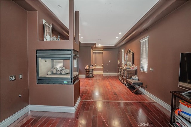 hall with crown molding and dark wood-type flooring