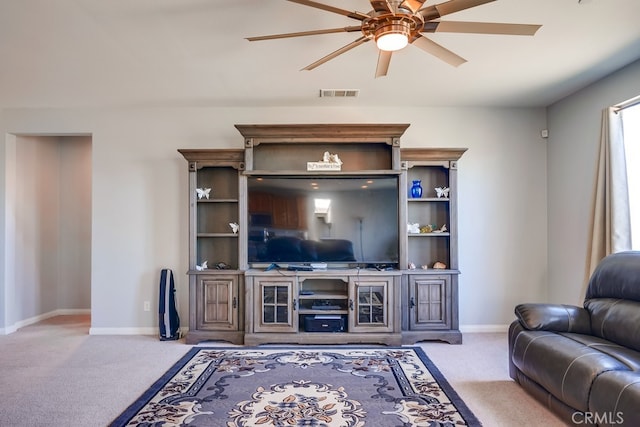 carpeted living room with ceiling fan