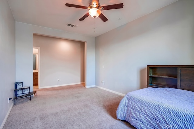 carpeted bedroom with connected bathroom and ceiling fan