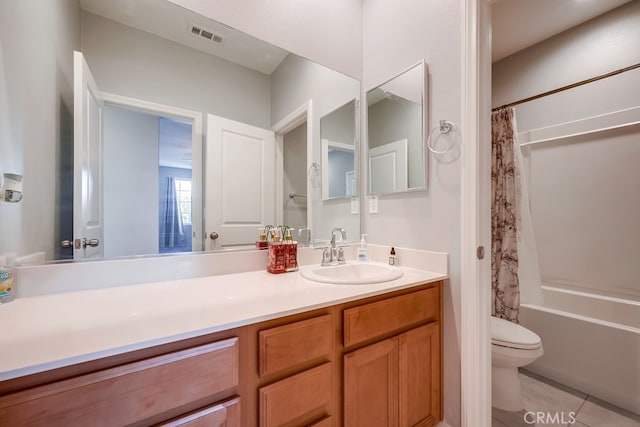 full bathroom with tile patterned floors, shower / bathtub combination with curtain, vanity, and toilet