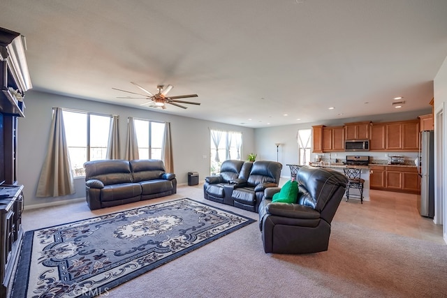 living room featuring ceiling fan and light carpet