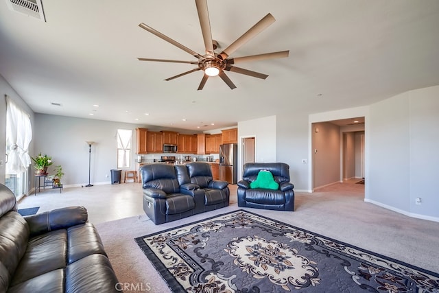 living room featuring ceiling fan and plenty of natural light