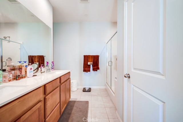 bathroom with vanity, tile patterned floors, and walk in shower