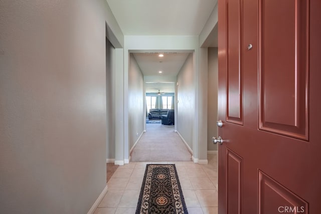 hall featuring light tile patterned floors