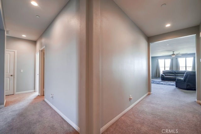 hallway with light colored carpet