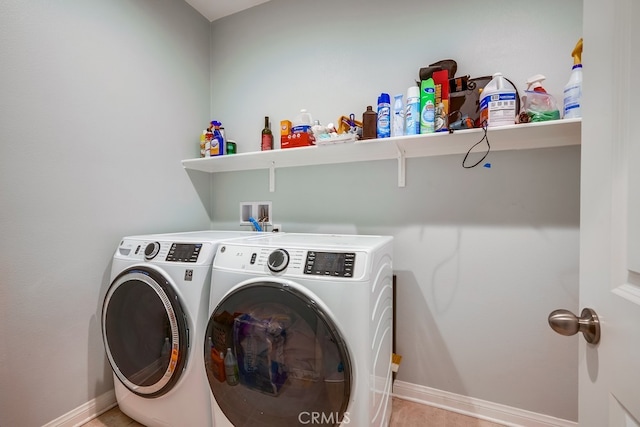 washroom featuring washer and clothes dryer and light tile patterned flooring