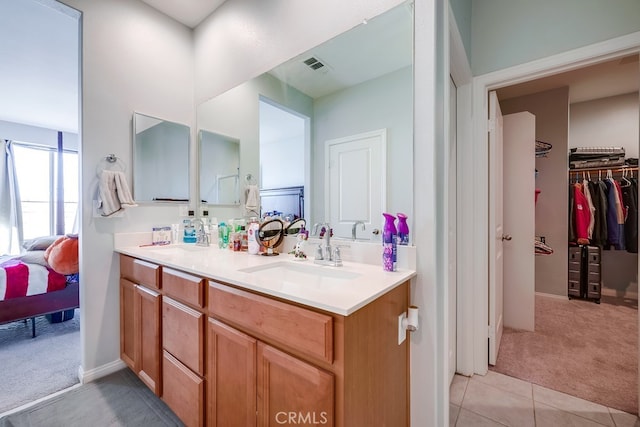 bathroom featuring tile patterned flooring and vanity