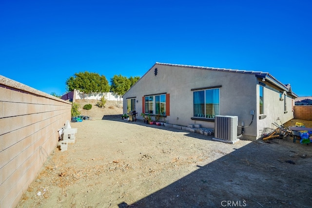 rear view of house with central AC unit