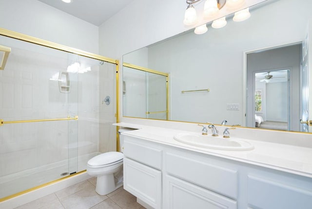 bathroom with ceiling fan, walk in shower, tile patterned flooring, toilet, and vanity