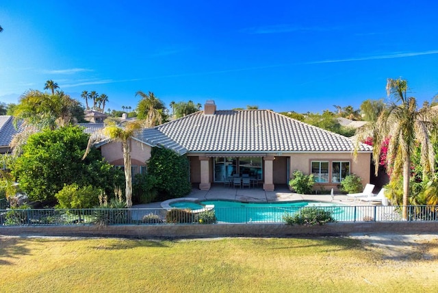 view of swimming pool with an in ground hot tub, a patio, and a lawn