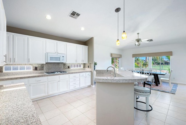 kitchen with ceiling fan, white cabinetry, and white appliances