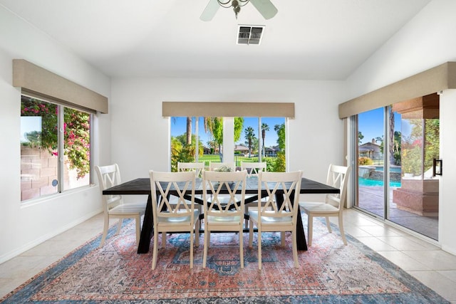 dining space with tile patterned floors and ceiling fan