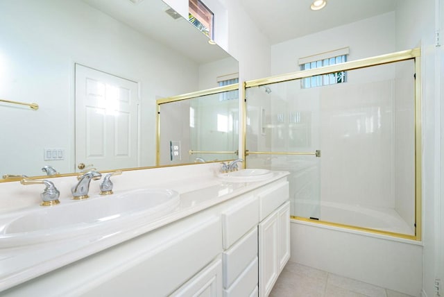 bathroom featuring tile patterned floors, vanity, and combined bath / shower with glass door