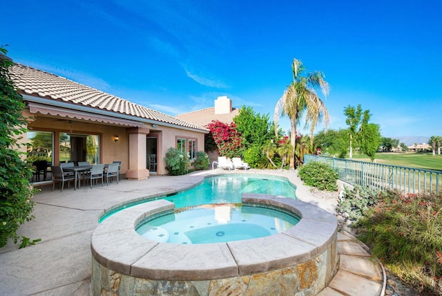 view of pool featuring a patio area and an in ground hot tub