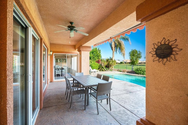 view of patio featuring ceiling fan and a fenced in pool