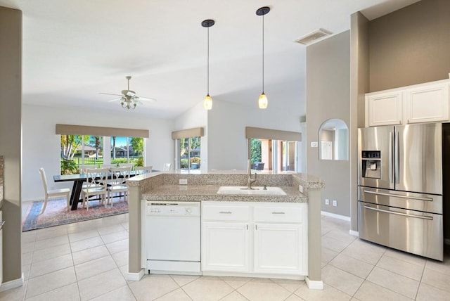 kitchen featuring white dishwasher, stainless steel fridge, white cabinetry, and sink