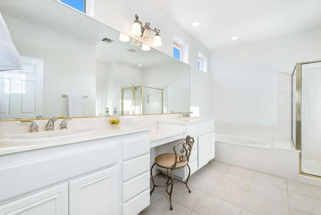 bathroom with tile patterned flooring, vanity, and shower with separate bathtub