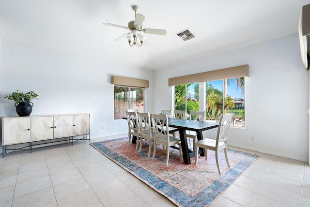 tiled dining space with ceiling fan