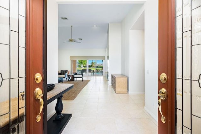 foyer with ceiling fan and light tile patterned floors