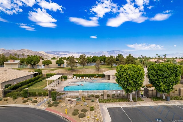 view of swimming pool with a mountain view and a patio