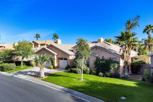 view of front of property with a garage and a front lawn